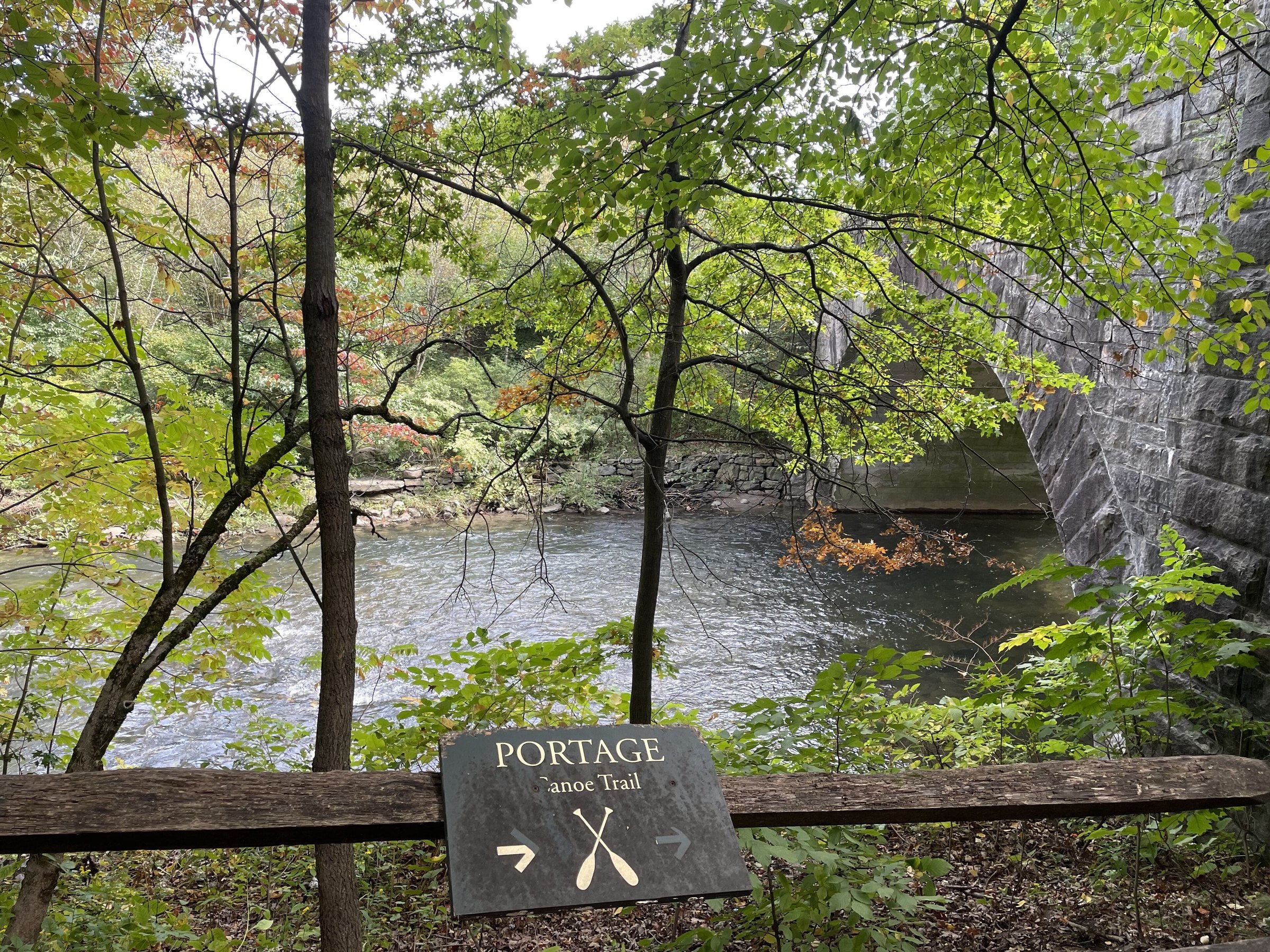 The Bronx River through the trees at the canoe portage trail in the New York Botanical Garden