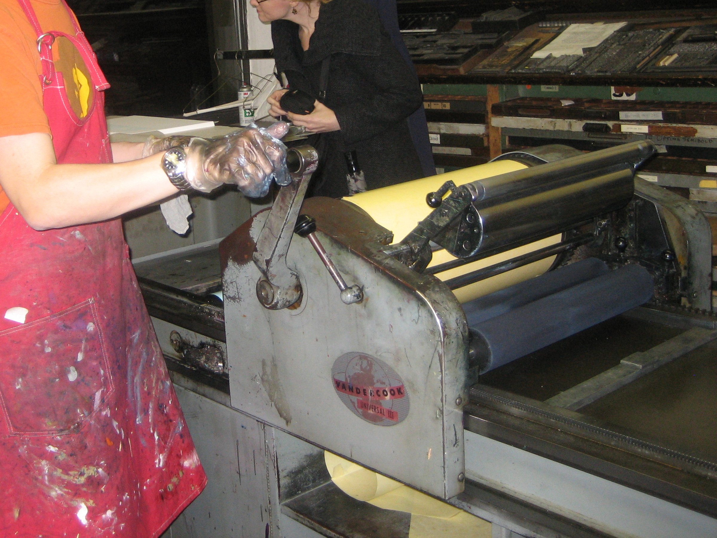 Inking up a cylinder press in the letterpress shop at the Center for Book Arts