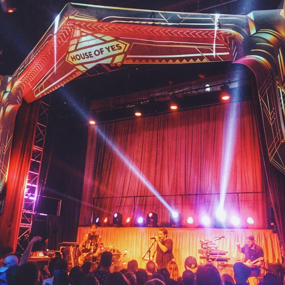 A show on the red-curtained stage at House of Yes in Bushwick, lights sweeping over the crowd