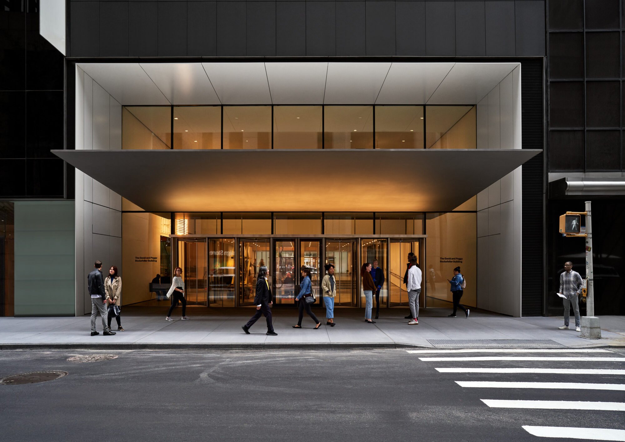 The Museum of Modern Art's main entrance on West 53rd Street, under its lit canopy