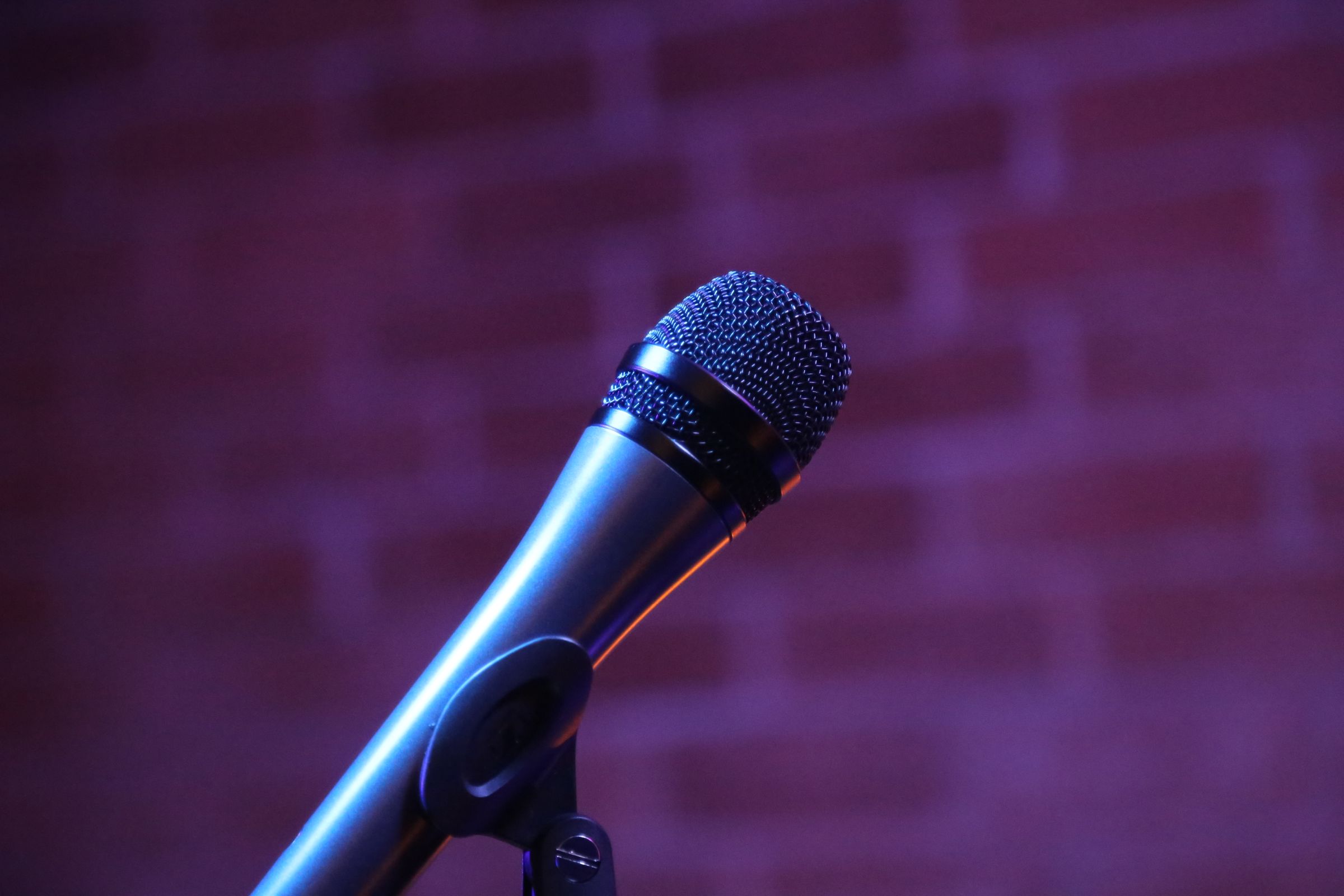 A microphone in front of a brick wall