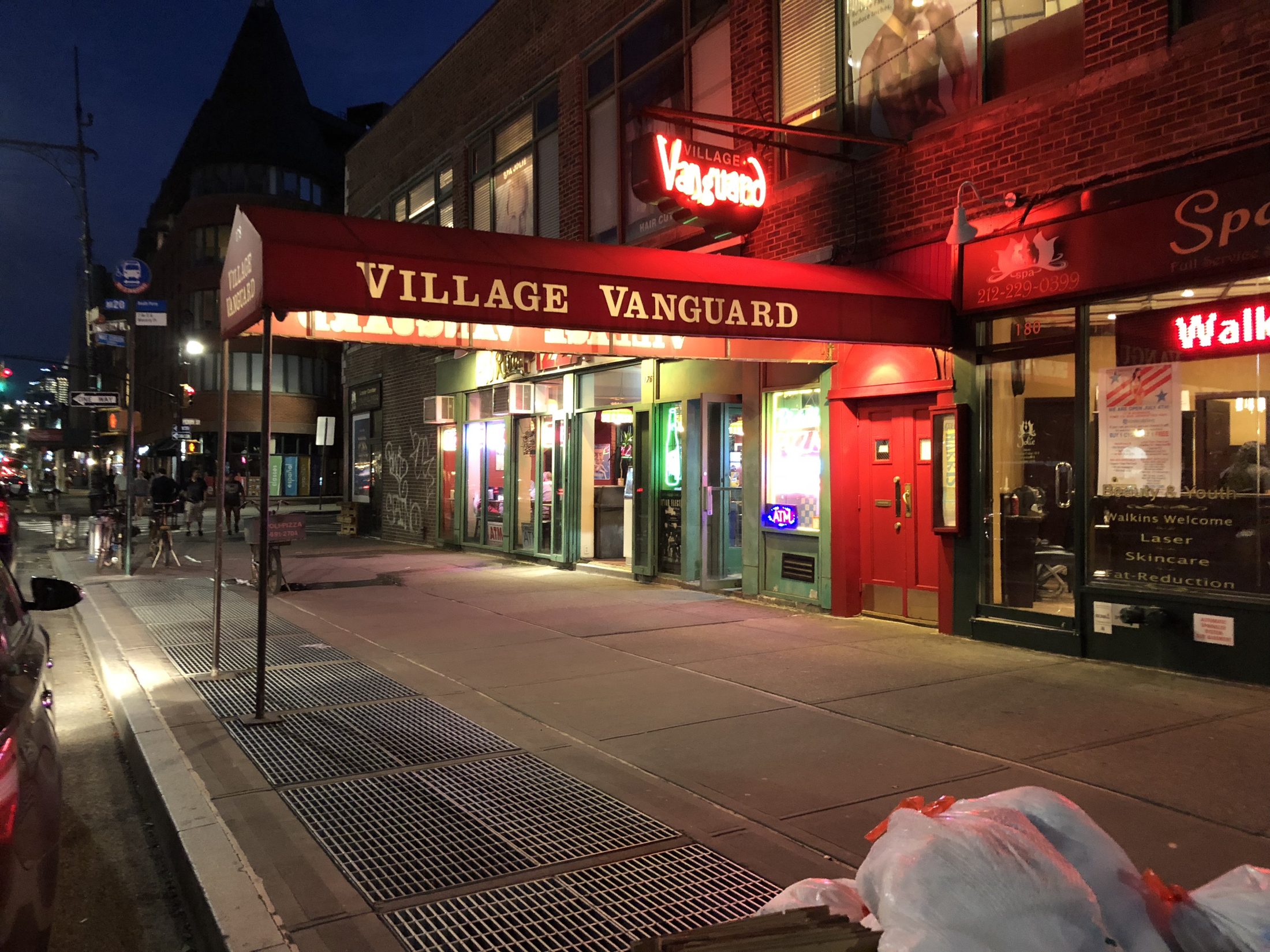 The Village Vanguard's red awning and entrance on Seventh Avenue South at night