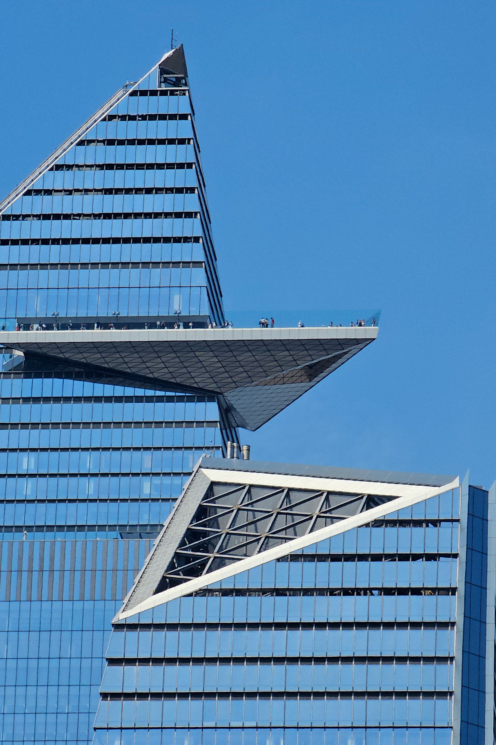 The triangular Edge observation deck jutting out from the upper floors of 30 Hudson Yards against a clear blue sky