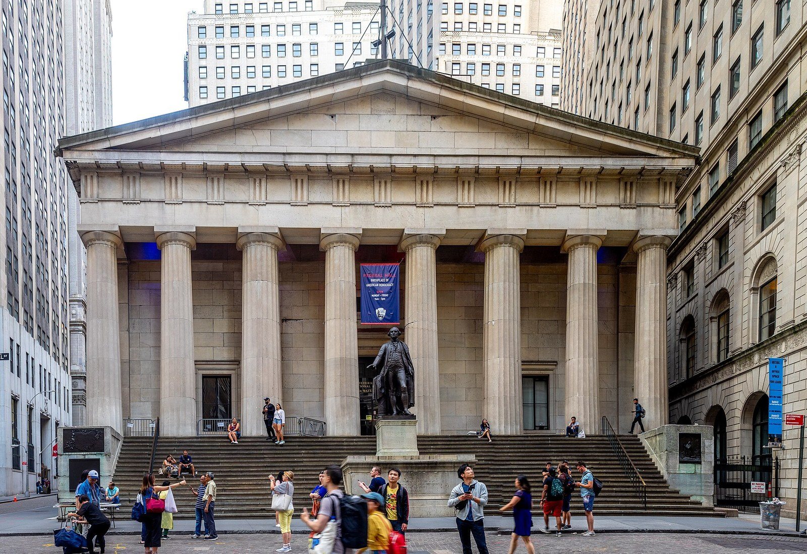 The columned facade of Federal Hall on Wall Street, with the statue of George Washington on the front steps