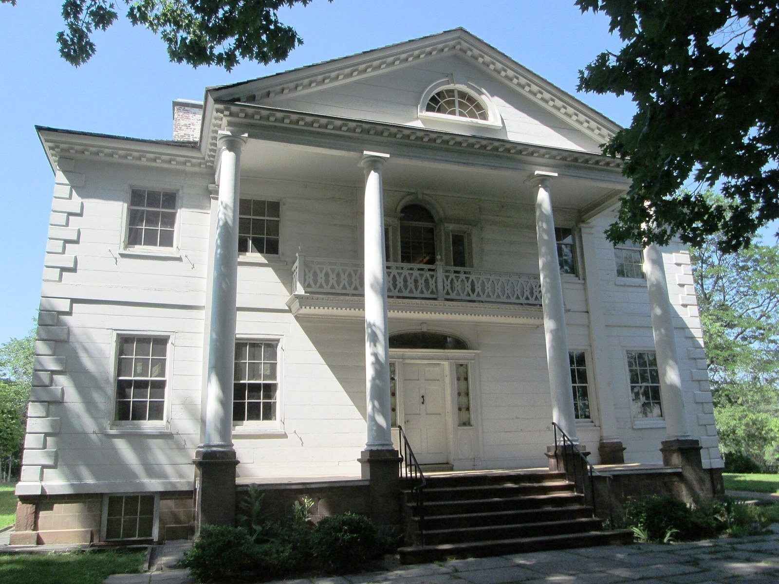 The white-columned portico of the Morris-Jumel Mansion above its lawn in Washington Heights