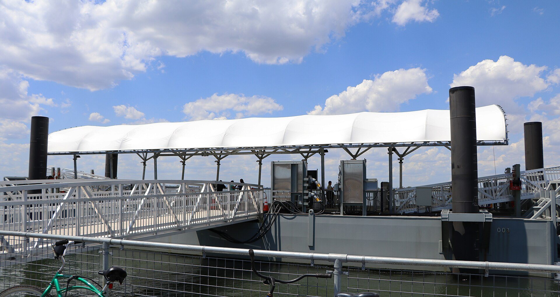 The NYC Ferry landing at Beach 108th Street in Rockaway, with its white canopy and gangway on Jamaica Bay