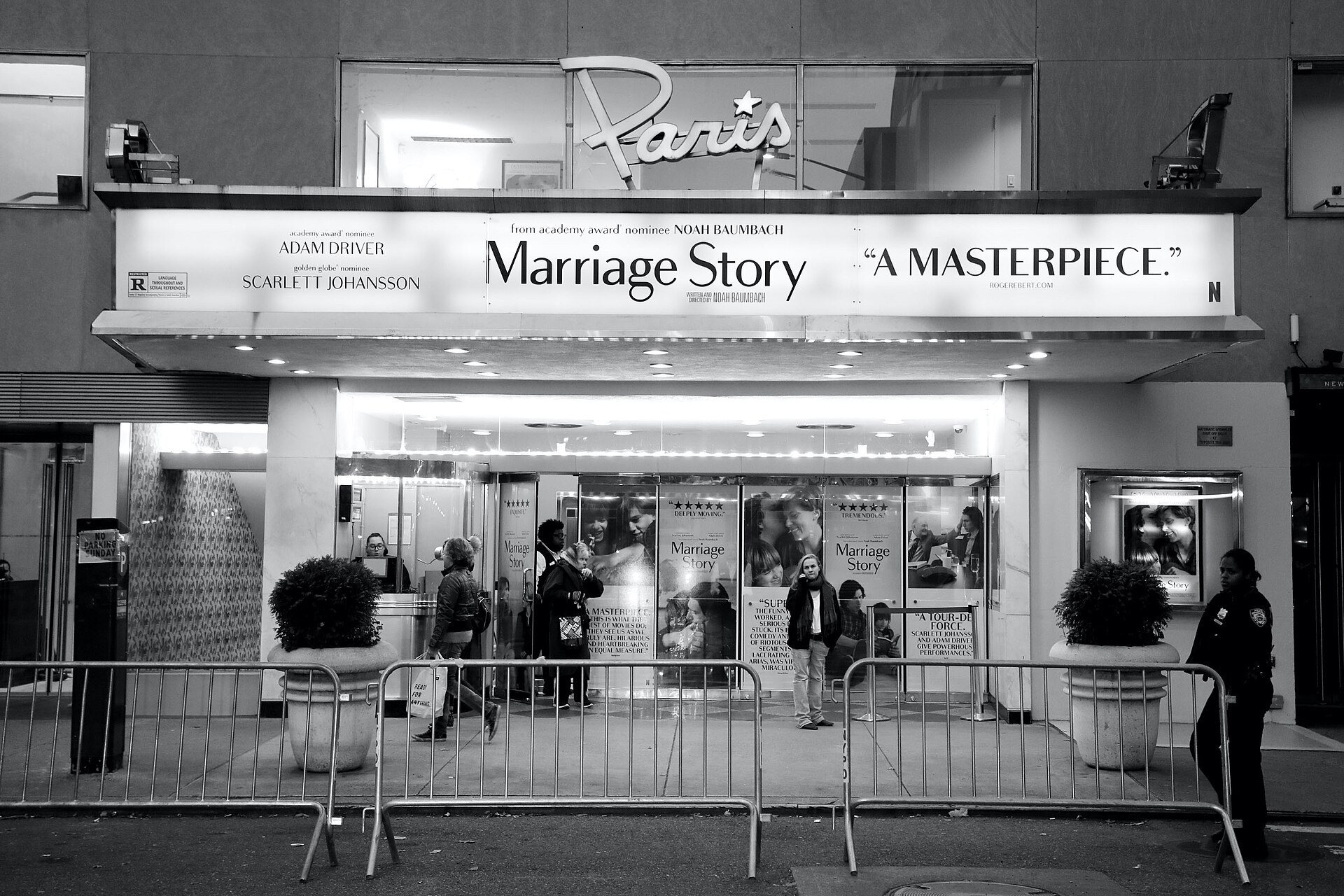 Black-and-white view of the Paris Theater marquee on West 58th Street, with a crowd under the canopy