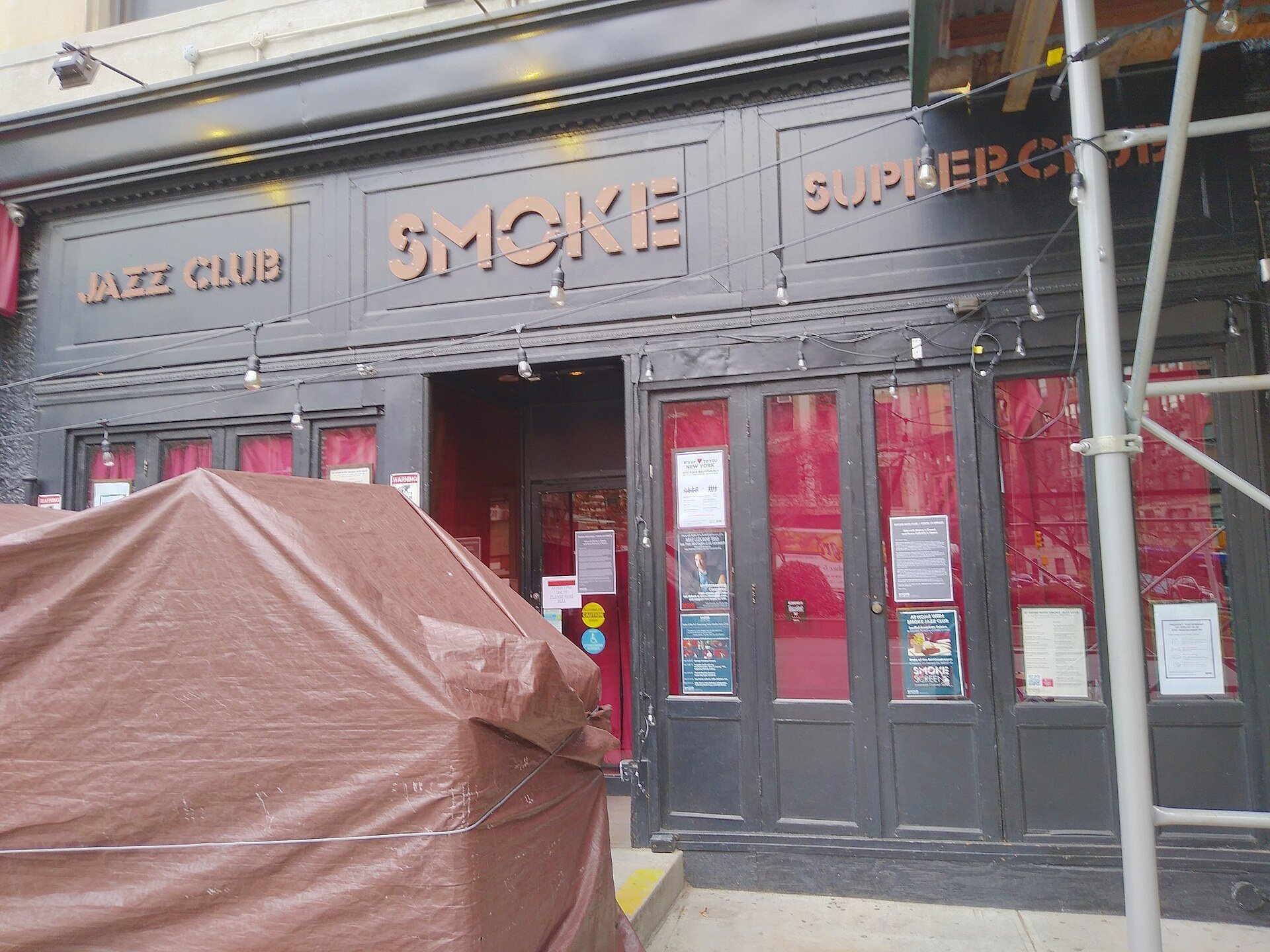 The dark-painted facade of Smoke Jazz & Supper Club on Broadway, with its name across the top