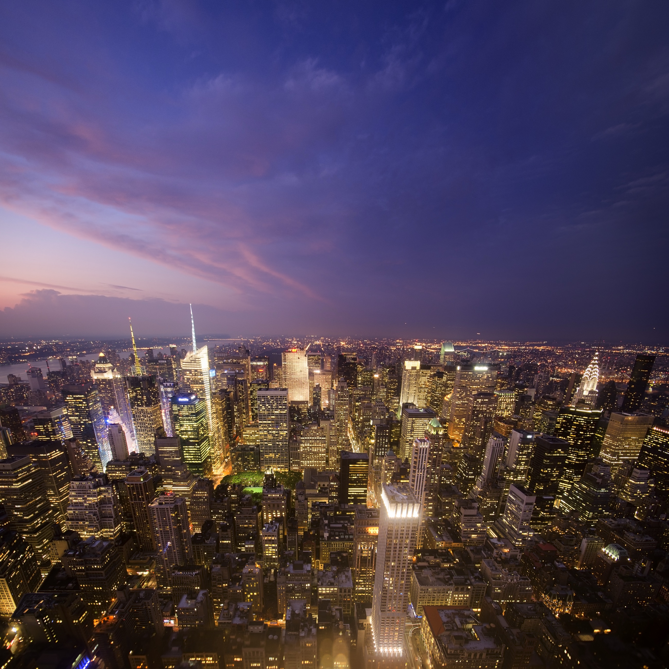 The Empire State Building and midtown skyline at dusk from an observation deck
