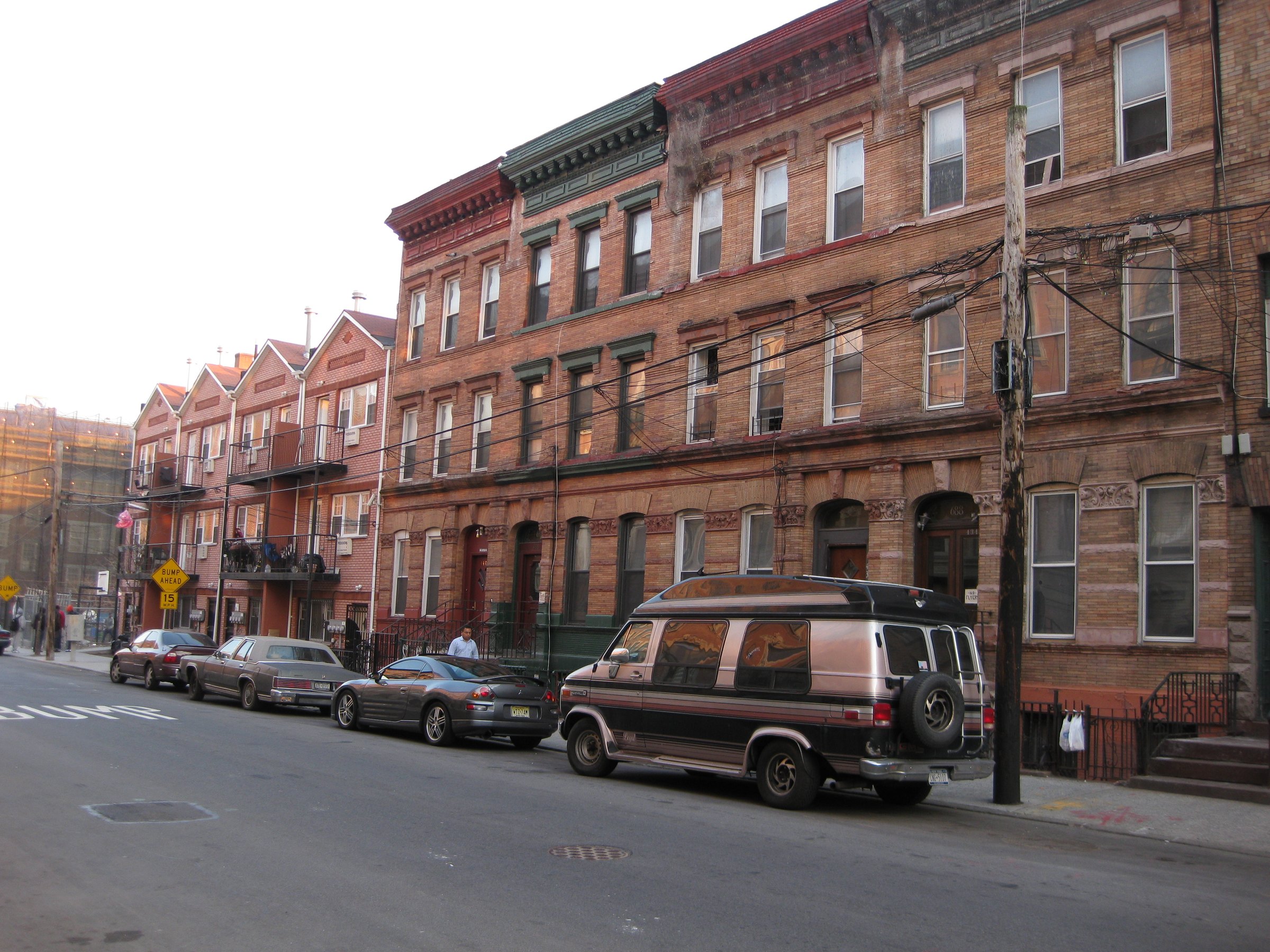 The Bertine Block's row of 1890s brick and brownstone houses on East 136th Street in Mott Haven