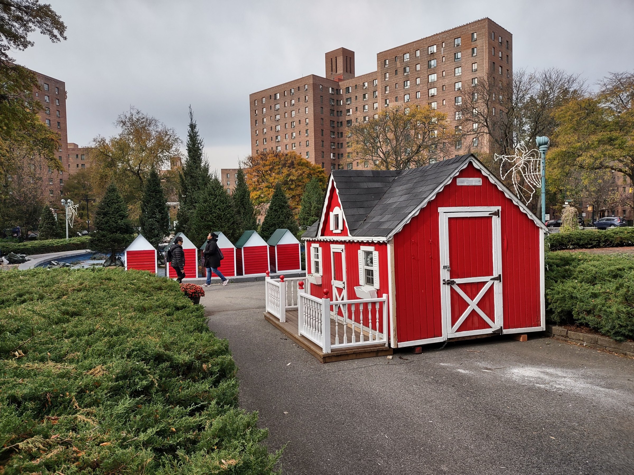 Metropolitan Oval at the heart of Parkchester, a little red playhouse among the hedges in front of the complex's brick towers