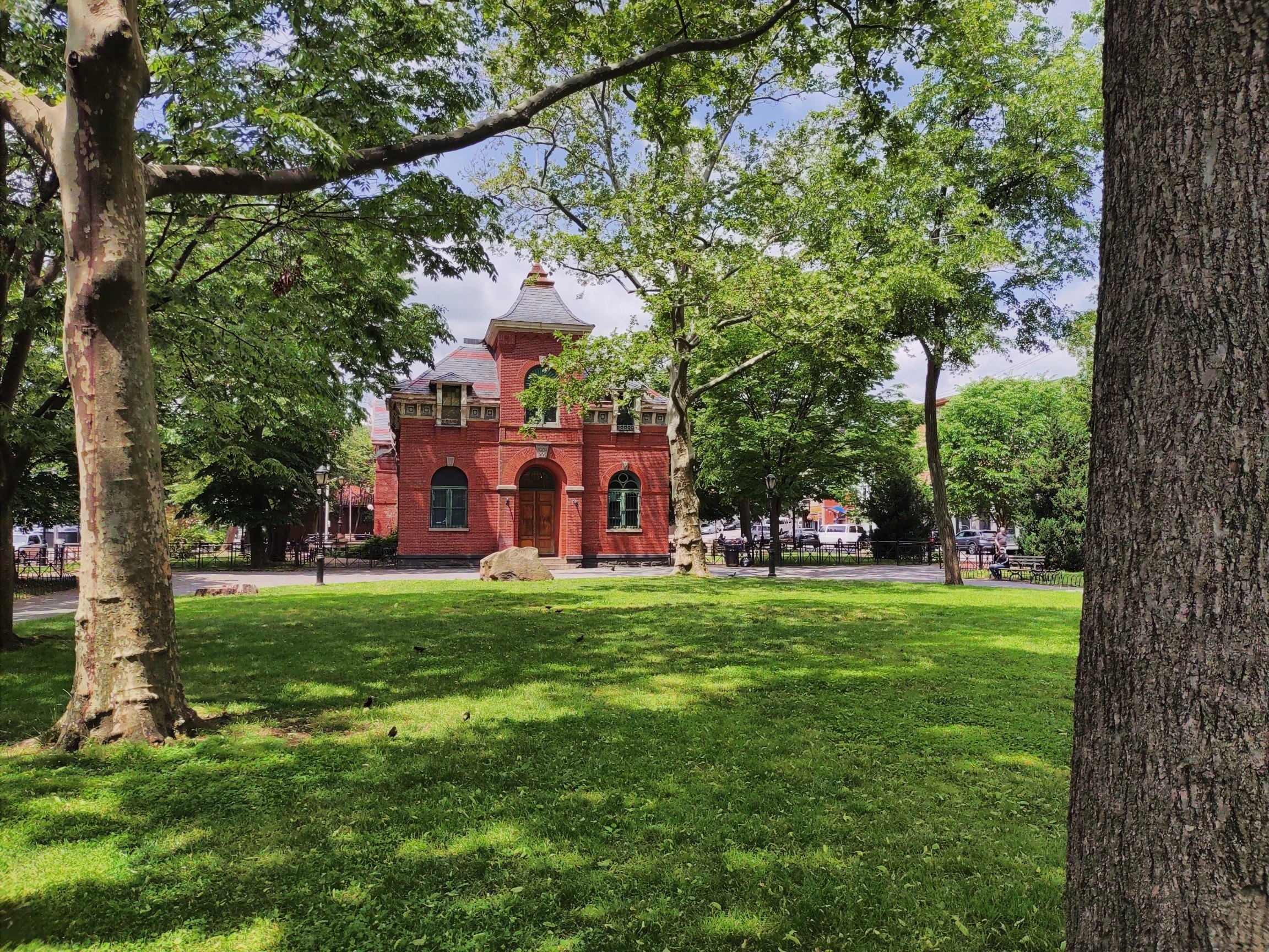 Tappen Park in Stapleton, with the red-brick Edgewater Village Hall behind the trees