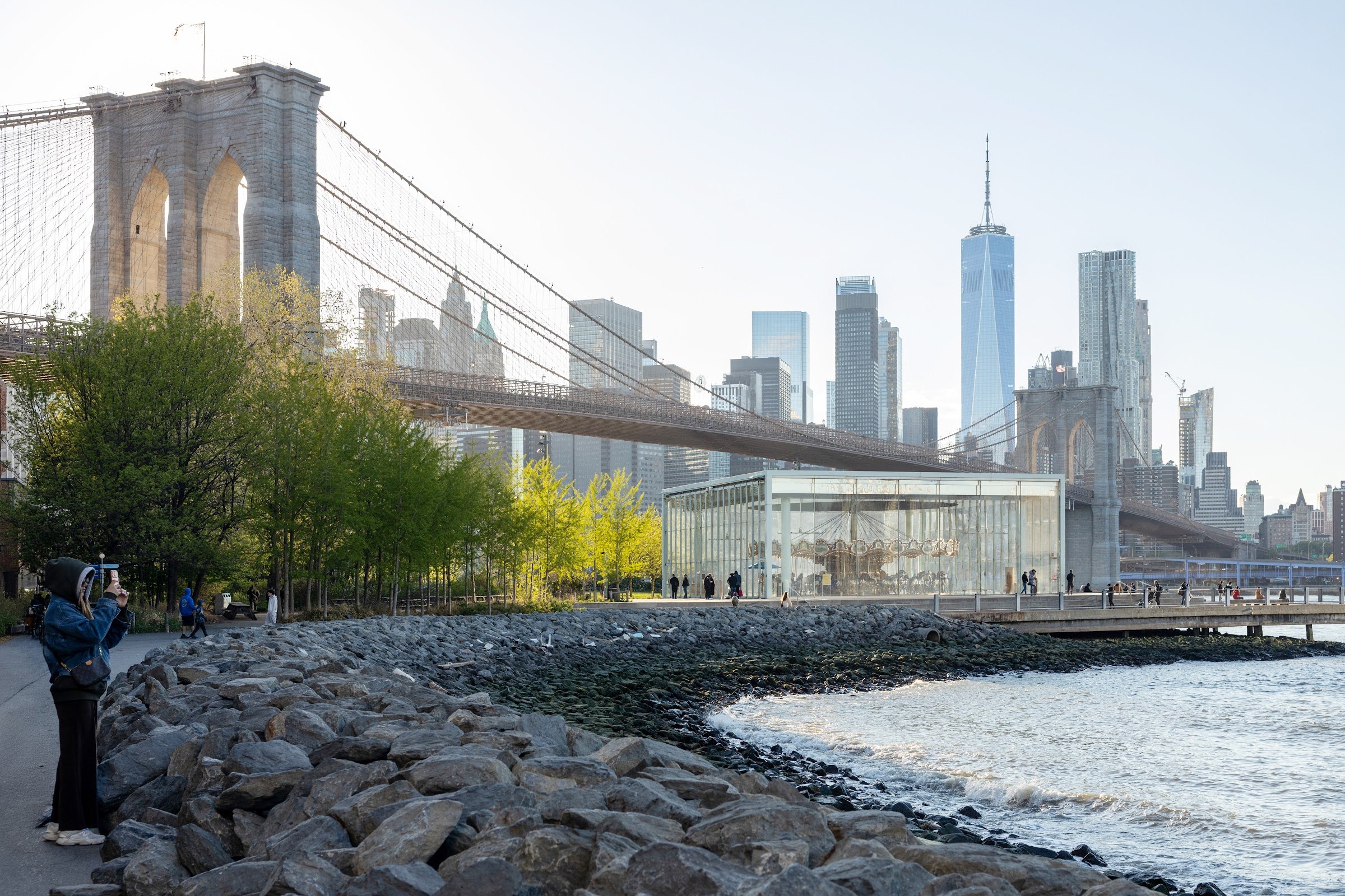 The Brooklyn Bridge, Jane's Carousel and Lower Manhattan seen from the shore of Brooklyn Bridge Park