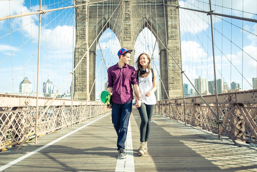 The Brooklyn Bridge's stone towers and steel cables seen from the pedestrian promenade