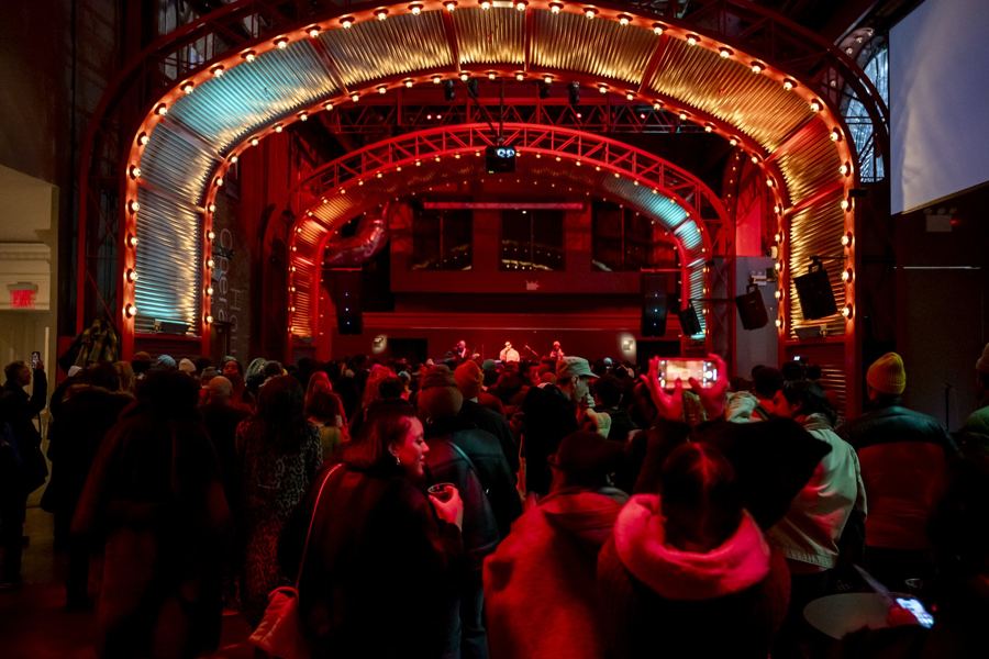 Bilal performing to a packed crowd in The Adam Space at BAM, under its lit proscenium arch
