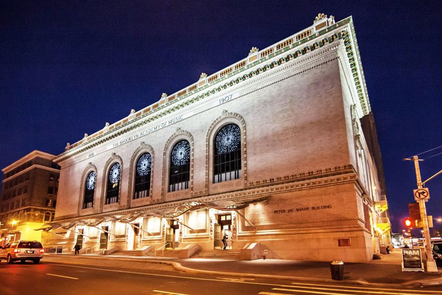 BAM's Peter Jay Sharp Building lit up at night on Lafayette Avenue in Fort Greene