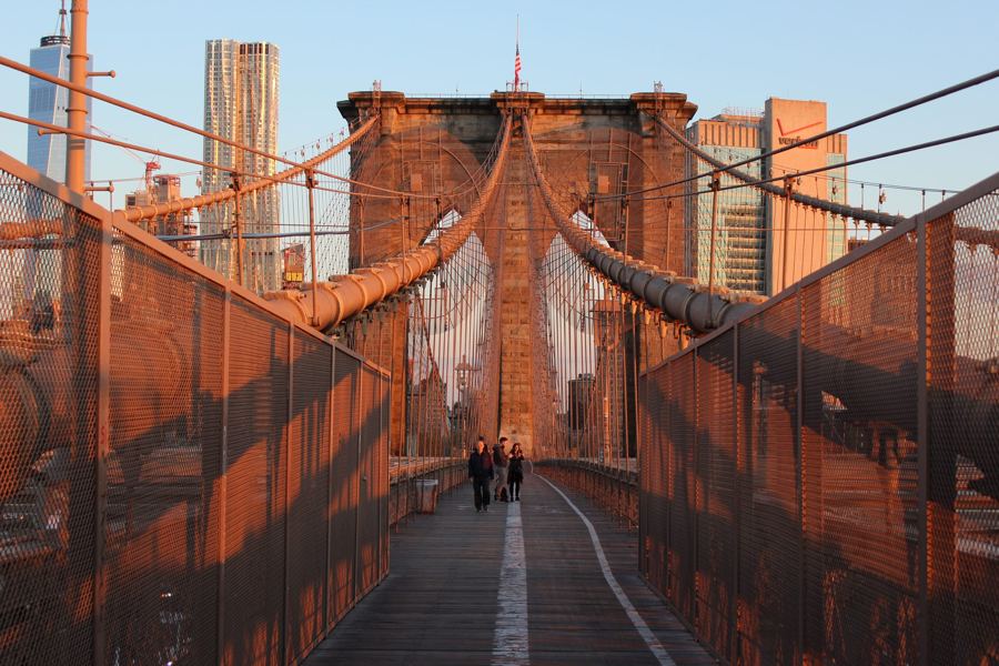 The Brooklyn Bridge promenade, cables and Gothic towers in early-morning light