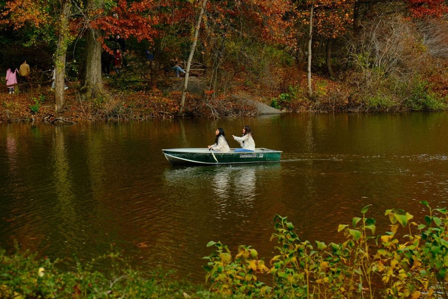 A couple in a rowboat on Central Park's Lake in fall