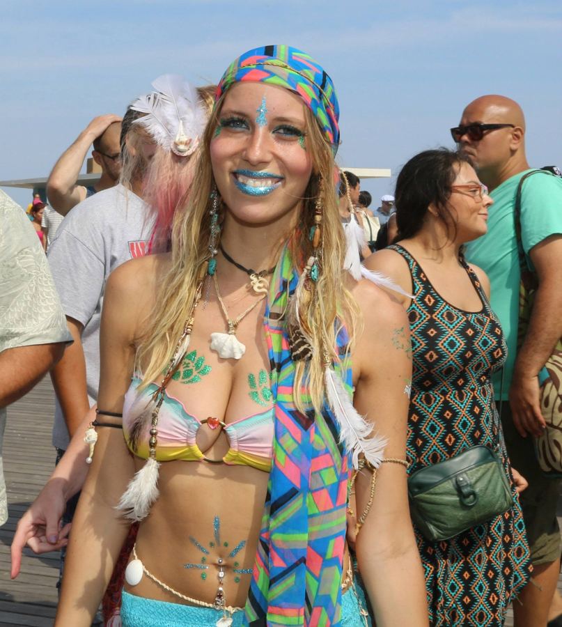 A paradegoer in a turban, body paint and shell top in the Mermaid Parade crowd
