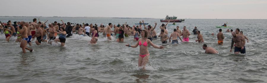 Hundreds of swimmers splashing in the winter Atlantic off Coney Island