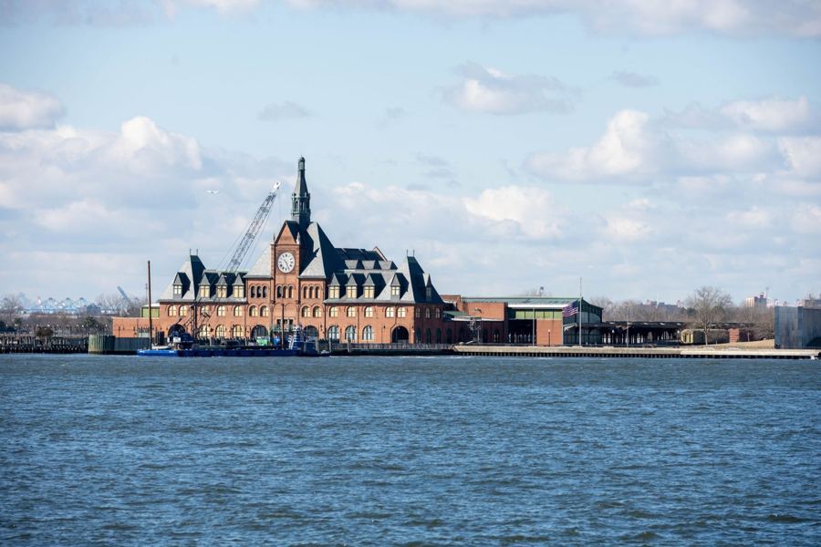 The red-brick main building of Ellis Island seen from the water