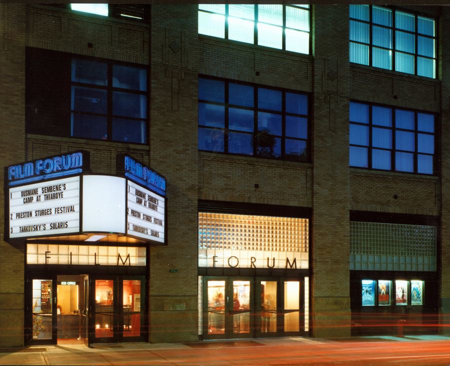 Film Forum's marquee and glass-block entrance on West Houston Street at dusk