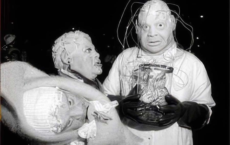 Two mad-scientist costumes carrying a brain in a jar