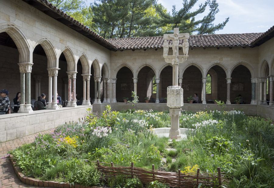 The Trie Cloister's medieval herb garden around a carved stone cross