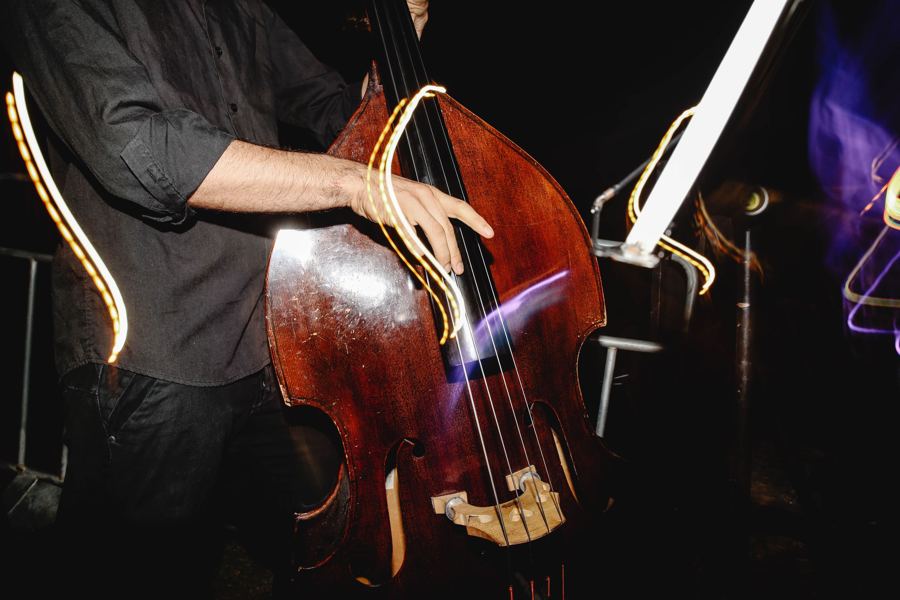 A double bass played in a dim jazz room