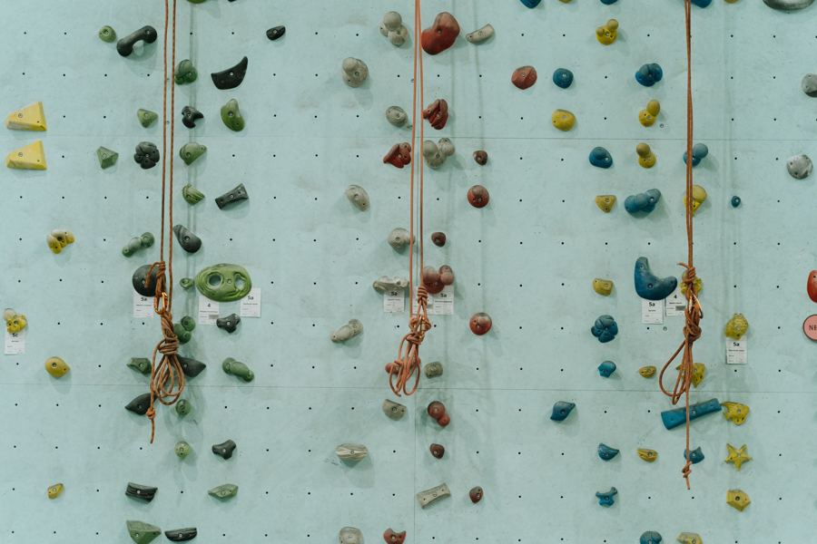 Rope-climbing routes on a tall indoor climbing wall