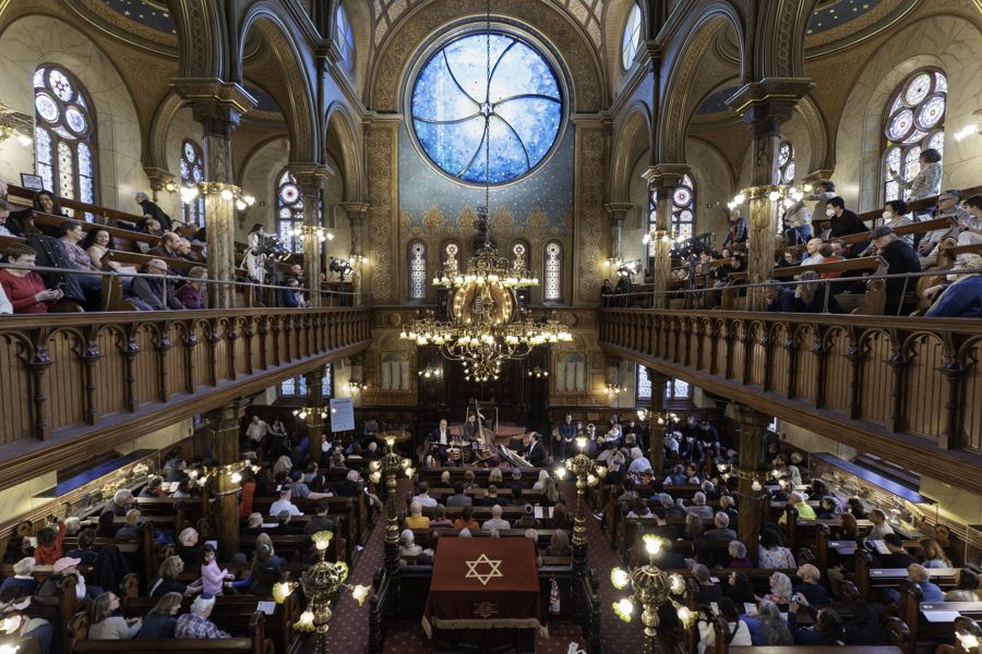 The restored sanctuary of the Museum at Eldridge Street, its great round window glowing above the ark