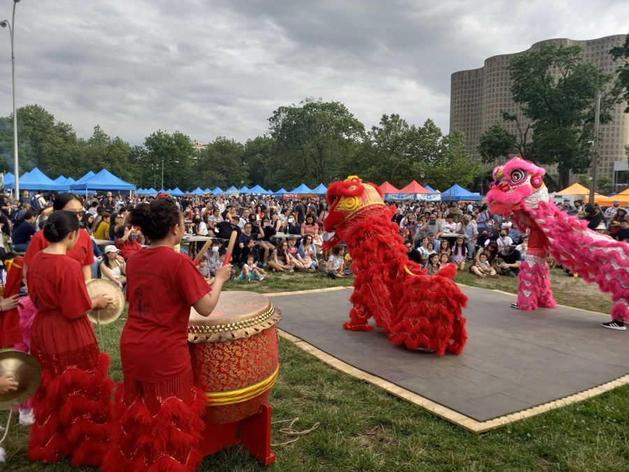 A lion dance on the grass at the Queens Night Market