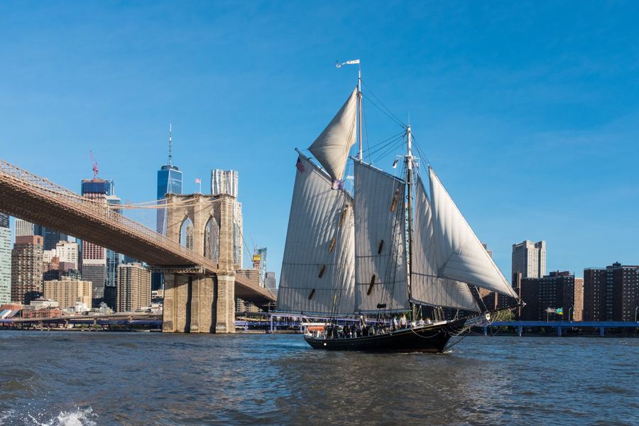 Pioneer sailing past the Brooklyn Bridge and Lower Manhattan