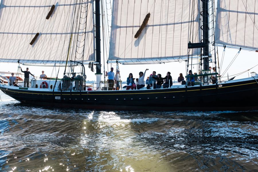 Passengers waving from the deck of the schooner Pioneer