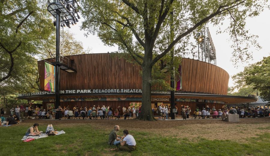 People picnicking on the lawn outside the Delacorte Theater in Central Park