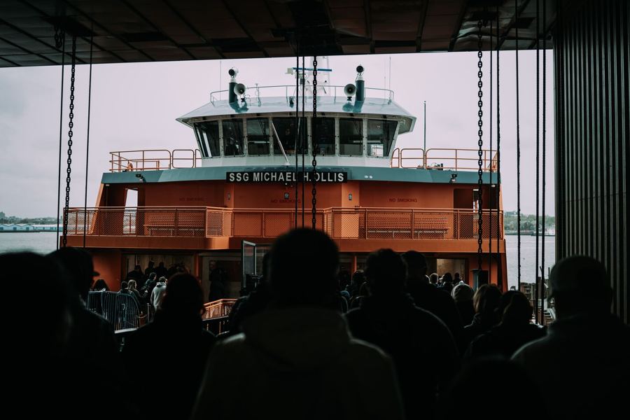 Passengers waiting as a Staten Island Ferry pulls into the slip