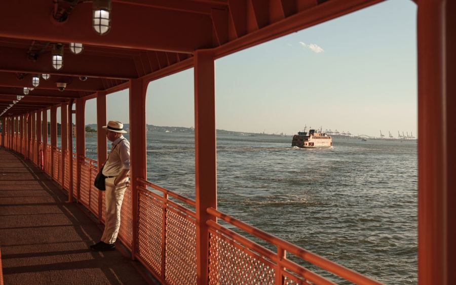 A rider on the outside deck of the Staten Island Ferry
