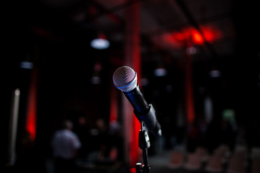A microphone on a dim basement stage