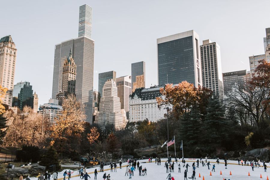 Skaters on Wollman Rink with Central Park South towers beyond