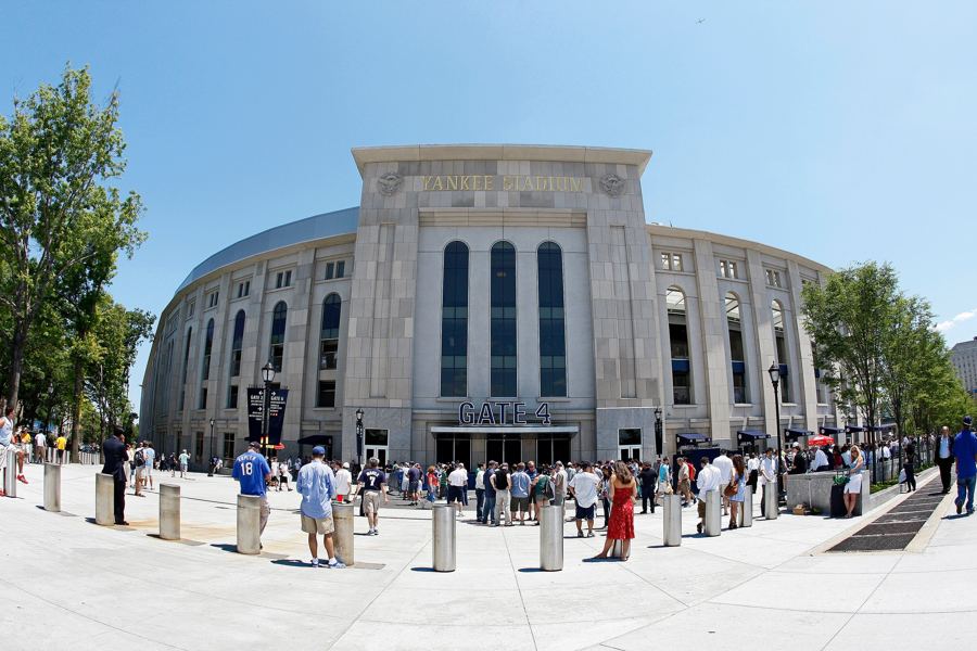 Yankee Stadium's limestone facade and Gate 4 on a sunny afternoon in the Bronx