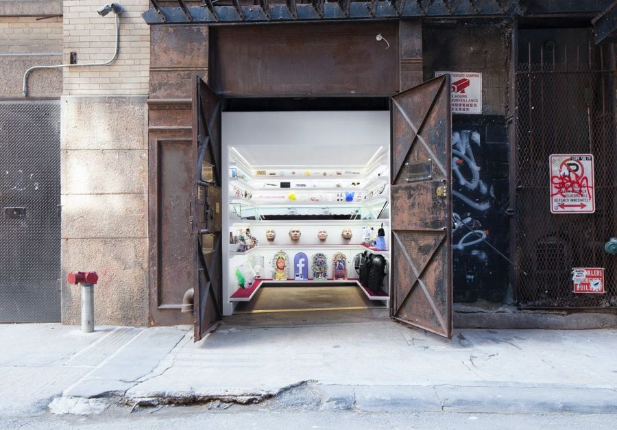 Mmuseumm's open steel doors in Cortlandt Alley, revealing lit shelves of objects inside a former freight elevator