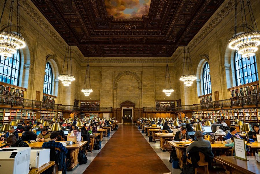 The Rose Main Reading Room, with readers at long wooden tables under chandeliers and a painted ceiling
