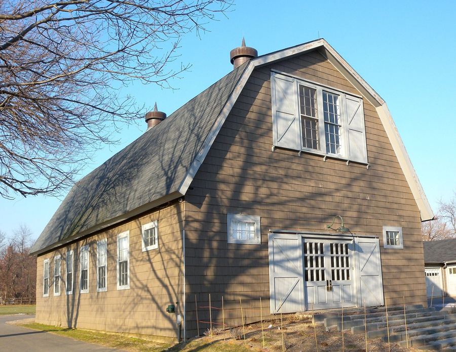 A weathered barn at the Queens County Farm Museum under a clear winter sky