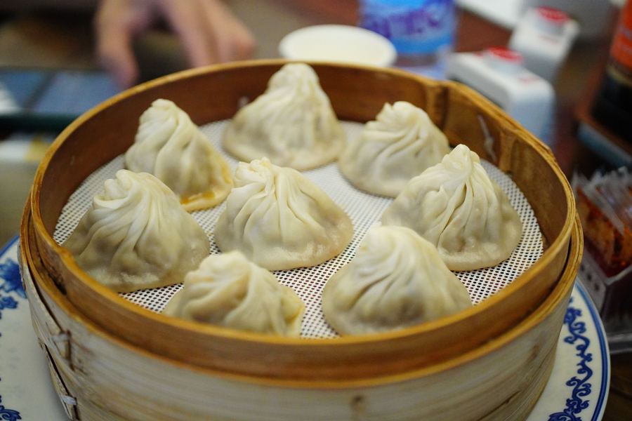 Soup dumplings in a paper-lined bamboo steamer