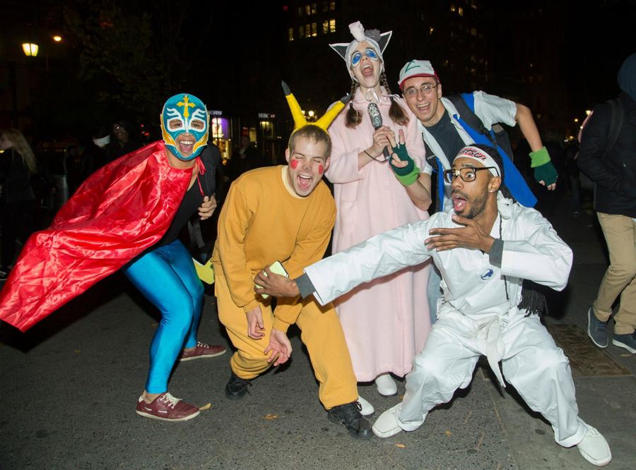 Friends dressed as a luchador, Pikachu and other characters strike poses at Union Square on Halloween night