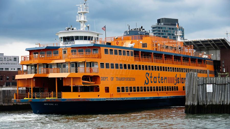 An orange Staten Island Ferry tied up at the terminal