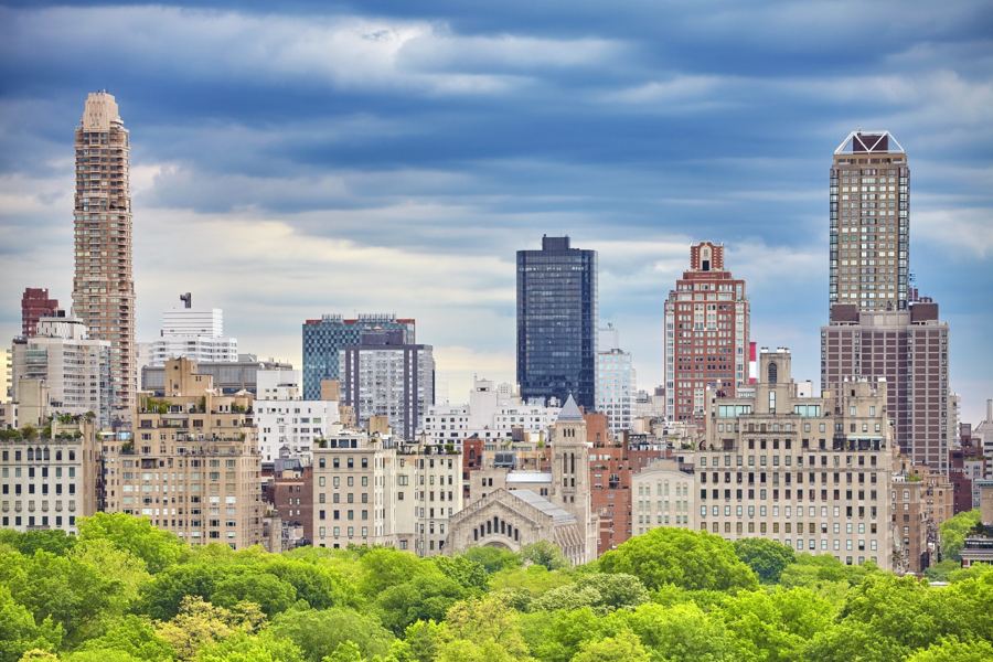 Fifth Avenue's prewar towers rising above the Central Park treeline on the Upper East Side