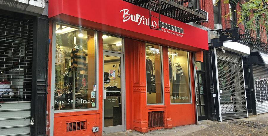 The red storefront of Buffalo Exchange on East 11th Street, Buy · Sell · Trade lettered on the window