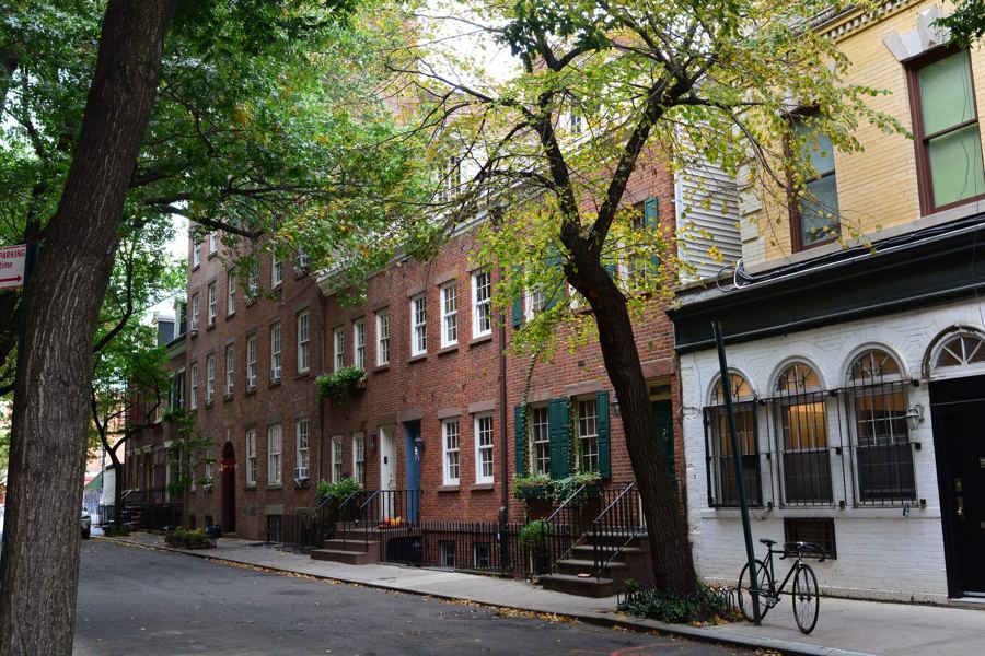 Brick rowhouses and street trees along the south side of Commerce Street in the West Village