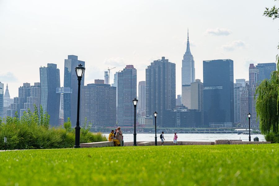 The lawn at Gantry Plaza State Park, with the Midtown skyline and the Empire State Building across the East River